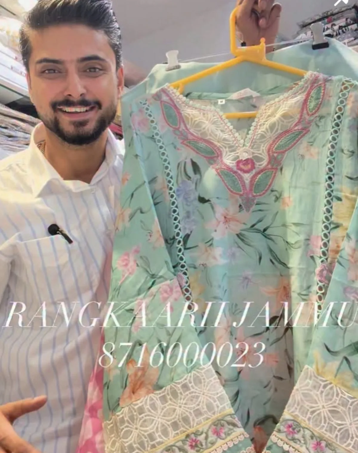 Mint floral kurta with a lace trim held up in the studio